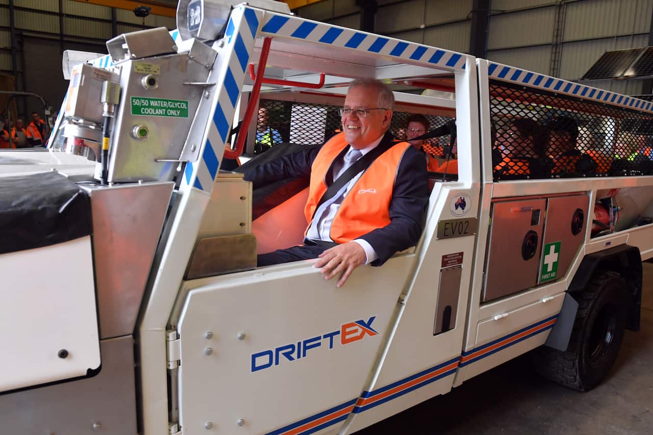Prime Minister Scott Morrison inside an electric vehicle at an engineering facility specialising in renewable technology during a visit to the Hunter Valley, Monday, November 8, 2021. (AAP Image/Mick Tsikas) NO ARCHIVING