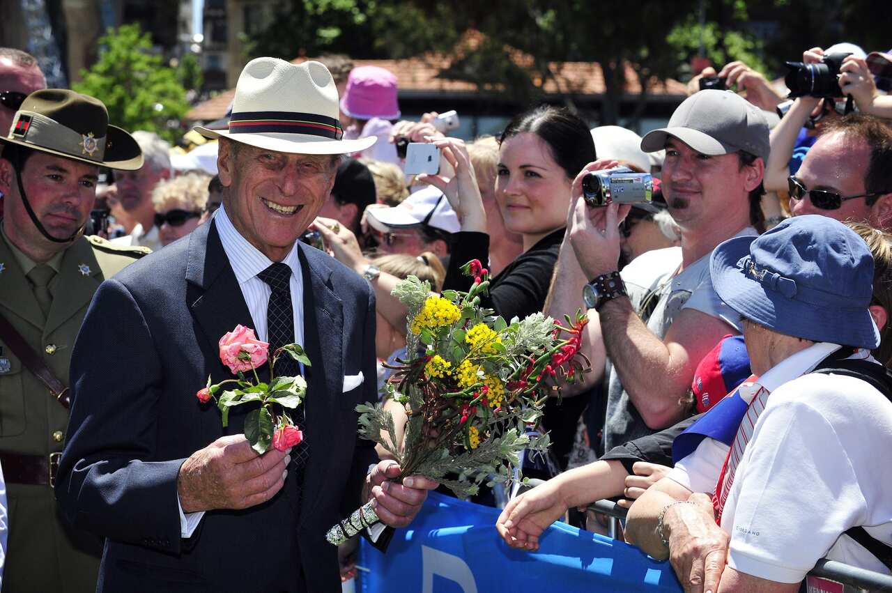 Prince Philip holding flowers as he greets the public during the Great Aussie Barbecue in Perth. 