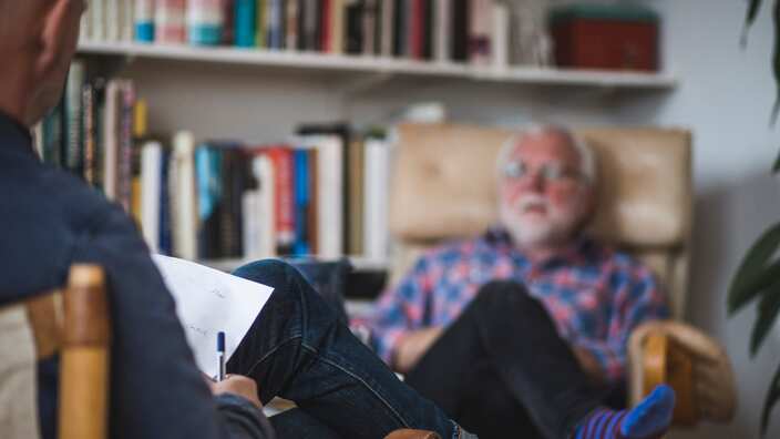 Male therapist with senior patient during therapy session