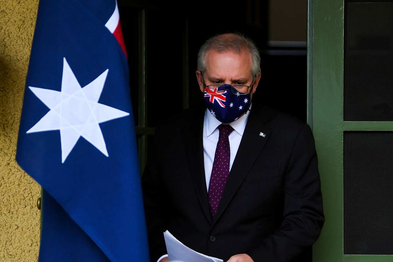 Australian Prime Minister Scott Morrison arrives to speak to the media during a press conference at the Lodge in Canberra, Sunday, July 25, 2021. (AAP Image/Lukas Coch) NO ARCHIVING