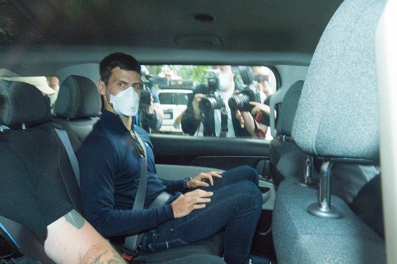 Serbian tennis player Novak Djokovic (centre) departs from the Park Hotel