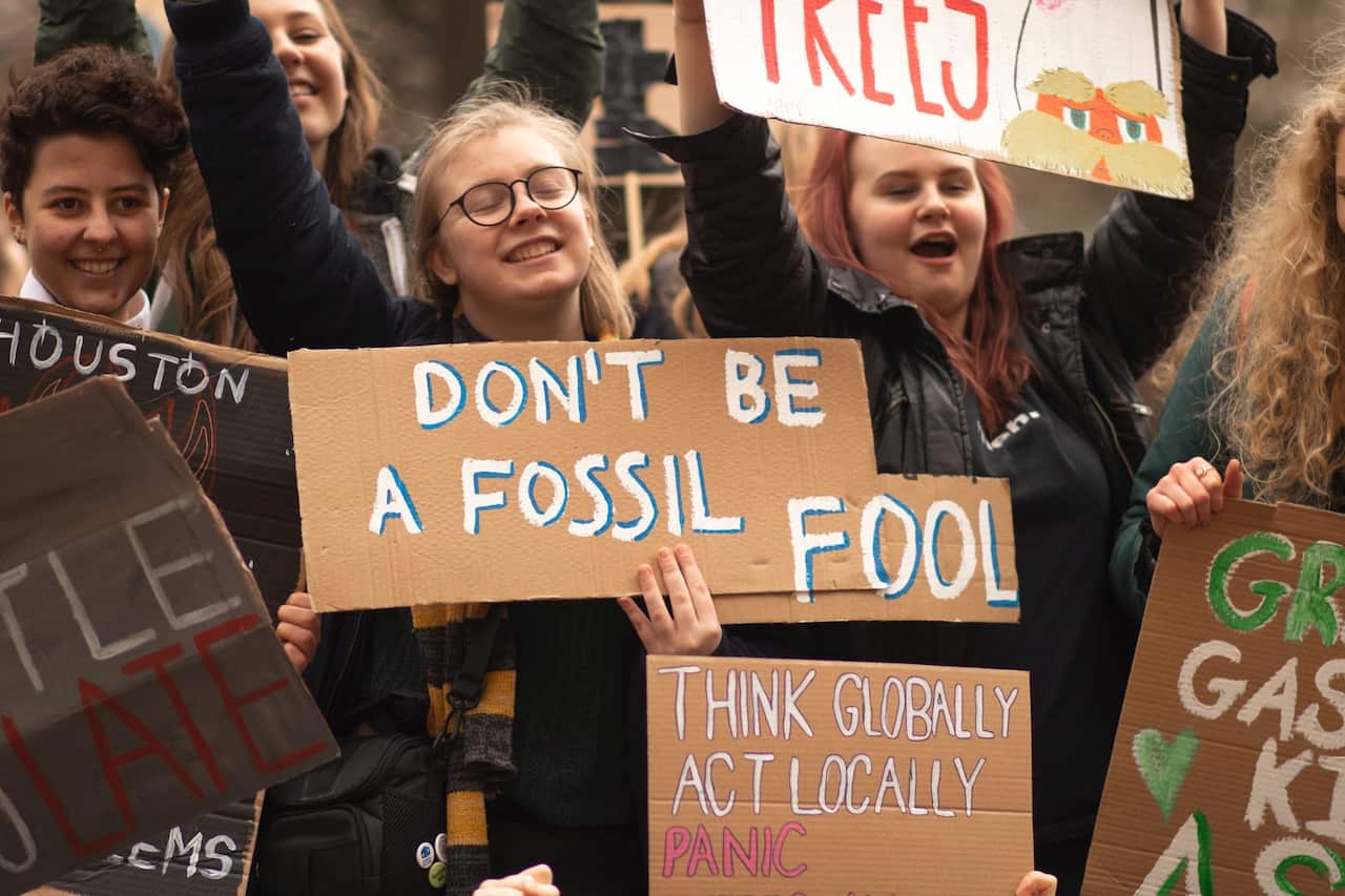 Students show signs climate change protest in Birmingham, UK - Callum Shaw-Unsplash