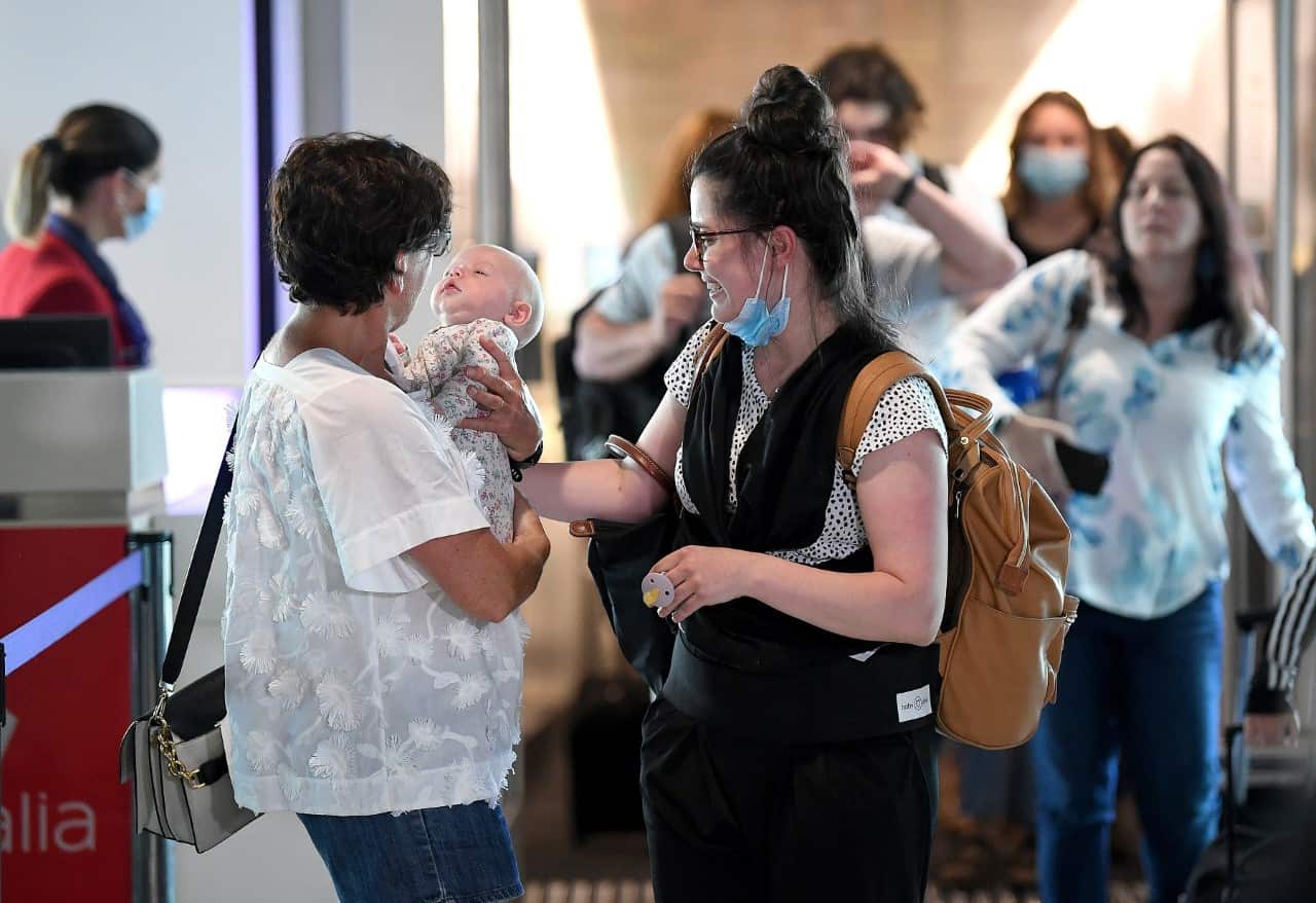 Passengers are reunited with loved-ones after arriving on the first flight from Melbourne at the Brisbane Domestic Airport (AAP)