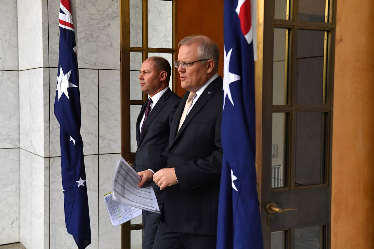 Treasurer Josh Frydenberg and Prime Minister Scott Morrison arrive to speak to the media during a press conference at Parliament House in Canberra, Thursday, March 12, 2020. (AAP Image/Mick Tsikas) NO ARCHIVING