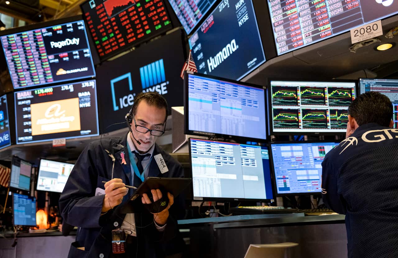 Trader Trader Gregory Rowe works on the floor of the New York Stock Exchange at the end of the trading day Monday, March 16, 2020. (AP Photo/Craig Ruttle)