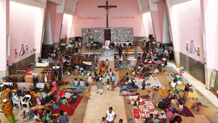 Women and children are seen inside a Roman Catholic Church in Pemba Mozambique