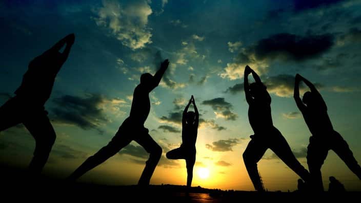 Indian children practice Yoga as the sun sets in the backdrop, as they prepare for the World Yoga Day in Bhopal, India, 20 June 2017. The International World Yoga Day will be observed on 21 June 2017.  EPA/SANJEEV GUPTA