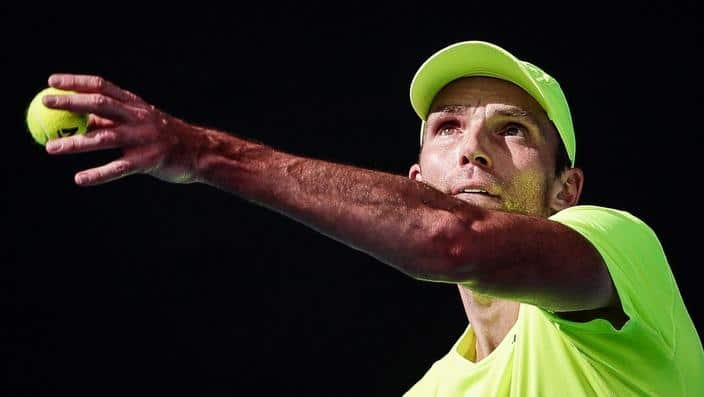Ivo Karlovic of Croatia serves the ball to Horacio Zeballos of Argentina