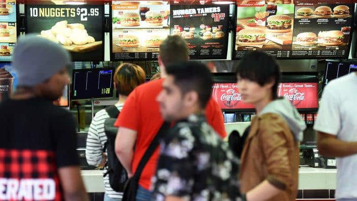 People line up to order at a fast food restaurant 