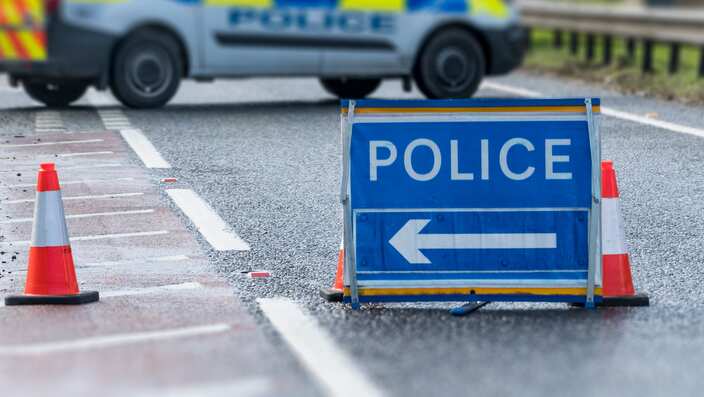 Police Sign on Road with Police Van