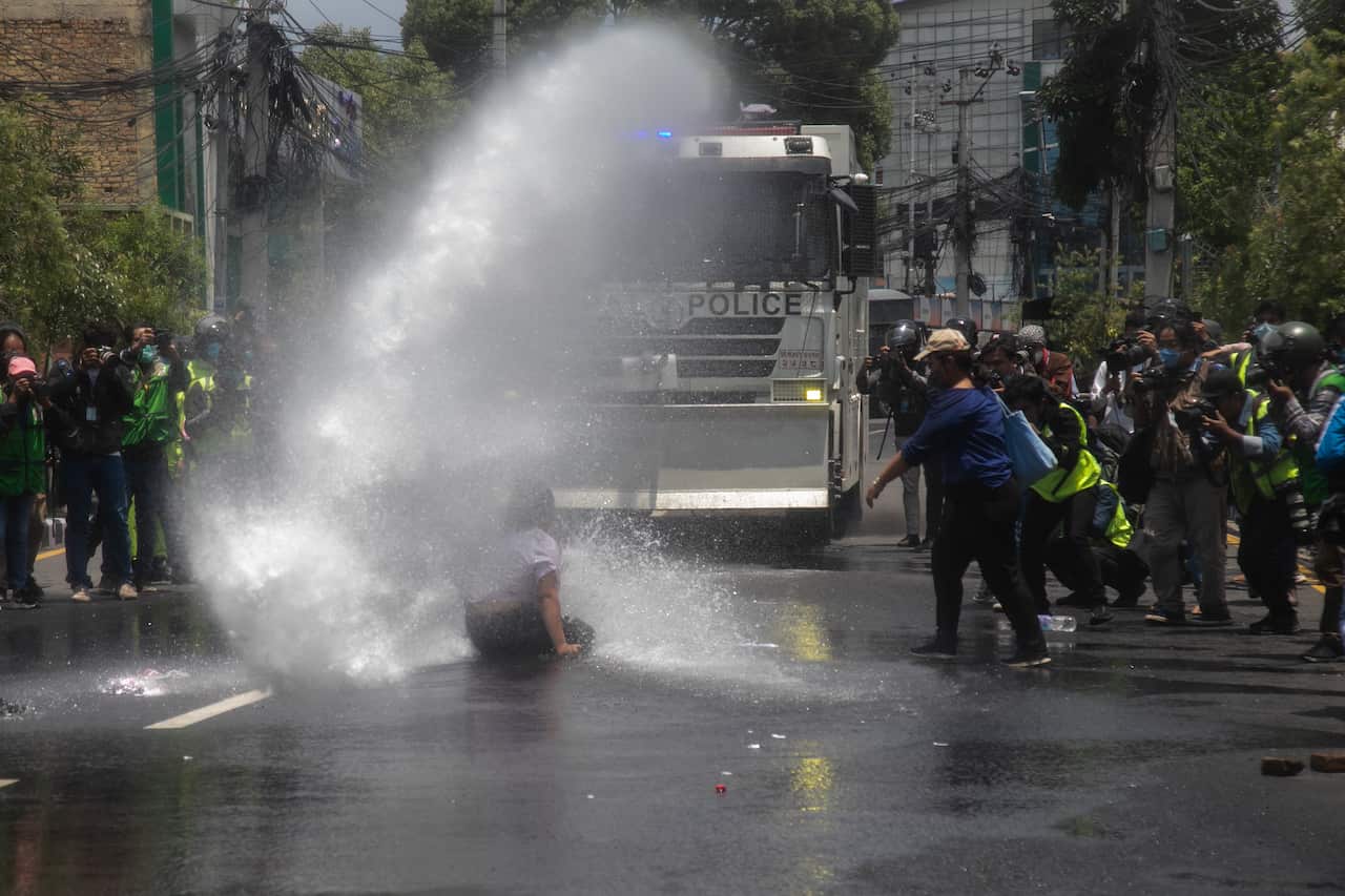 Police sprays youth using a water canon during a protest as they demand government a better and effective response on the fight of the novel Coronavirus (COVID-19) 