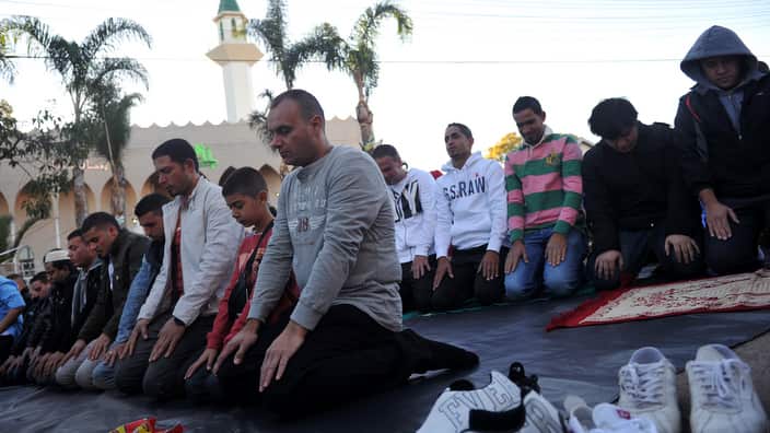 Muslims gather outside the Lakemba Mosque for morning prayers on Eid ul-Fitr to mark the end of Ramadan in Sydney