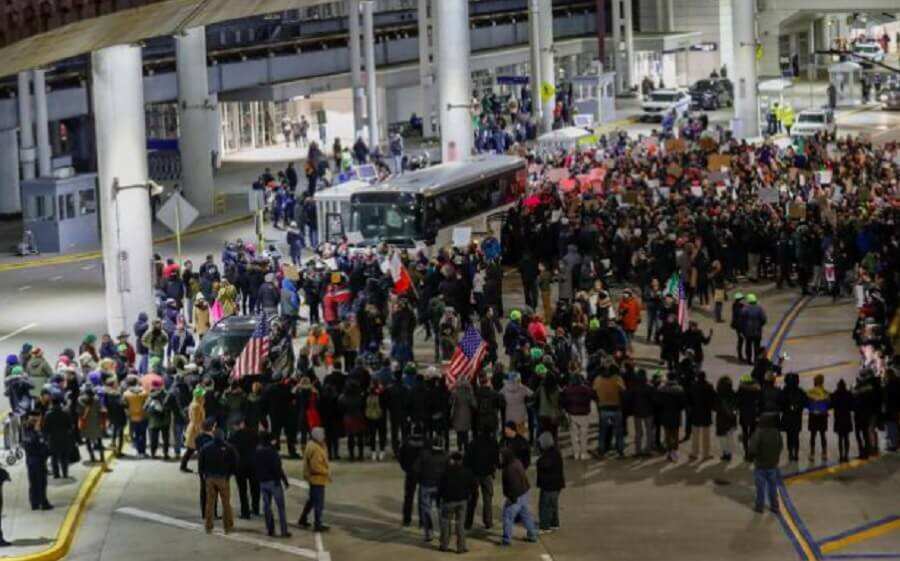 Above: Protesters against Trump's Muslim ban at O'Hare airport in Chicago.