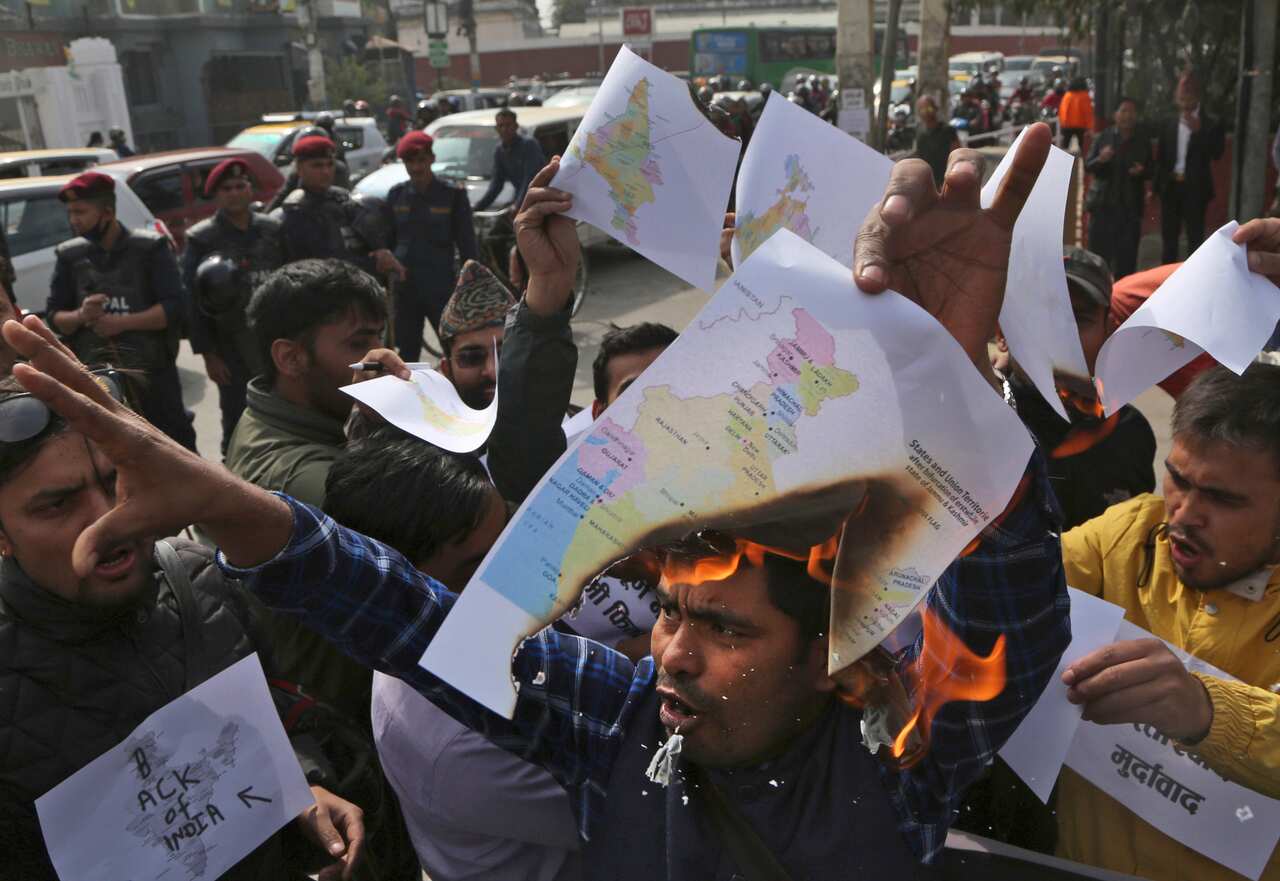 Nepalese students burns Indian map during a protest near Indian embassy in Kathmandu, Nepal, Friday, Nov 8, 2019.