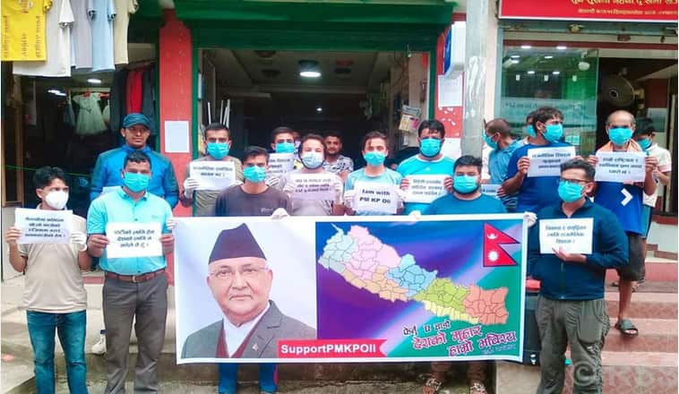 Supporters of Nepal's PM Oli holding banners in Kathmandu amid calls by his party members to resign