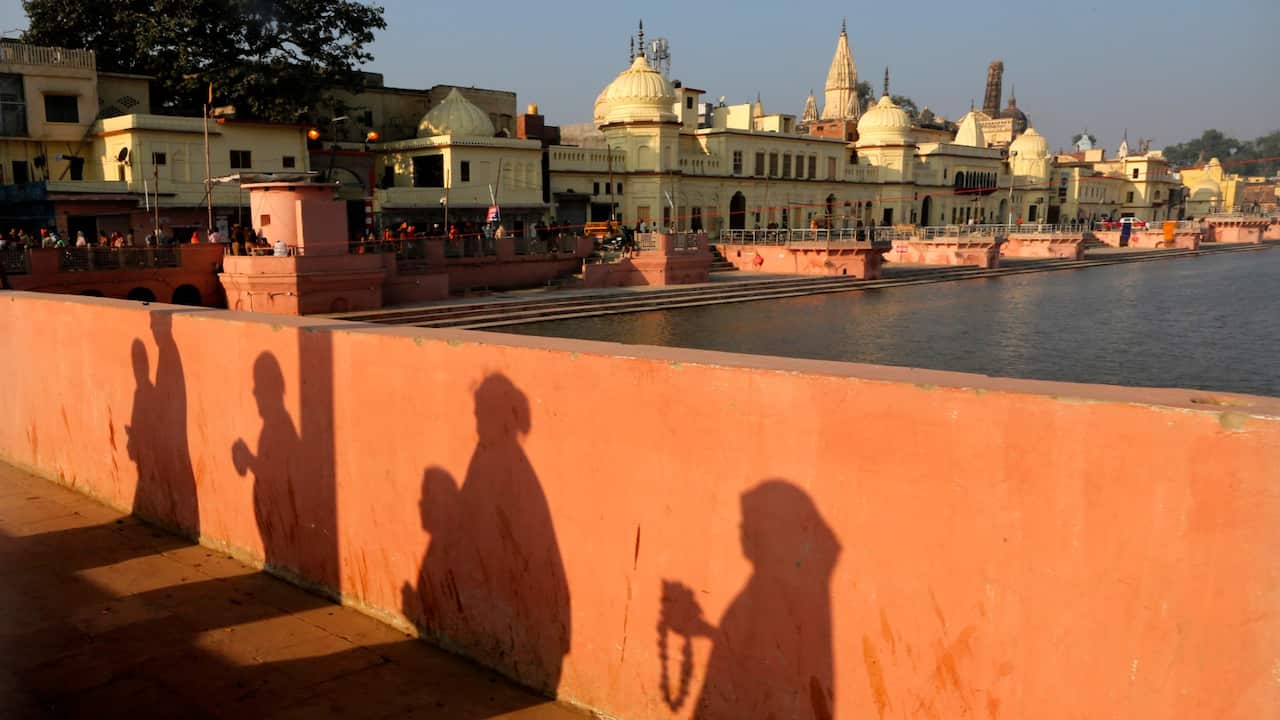 Hindu devotees pray while walking towards a temple, in Ayodhya, India.