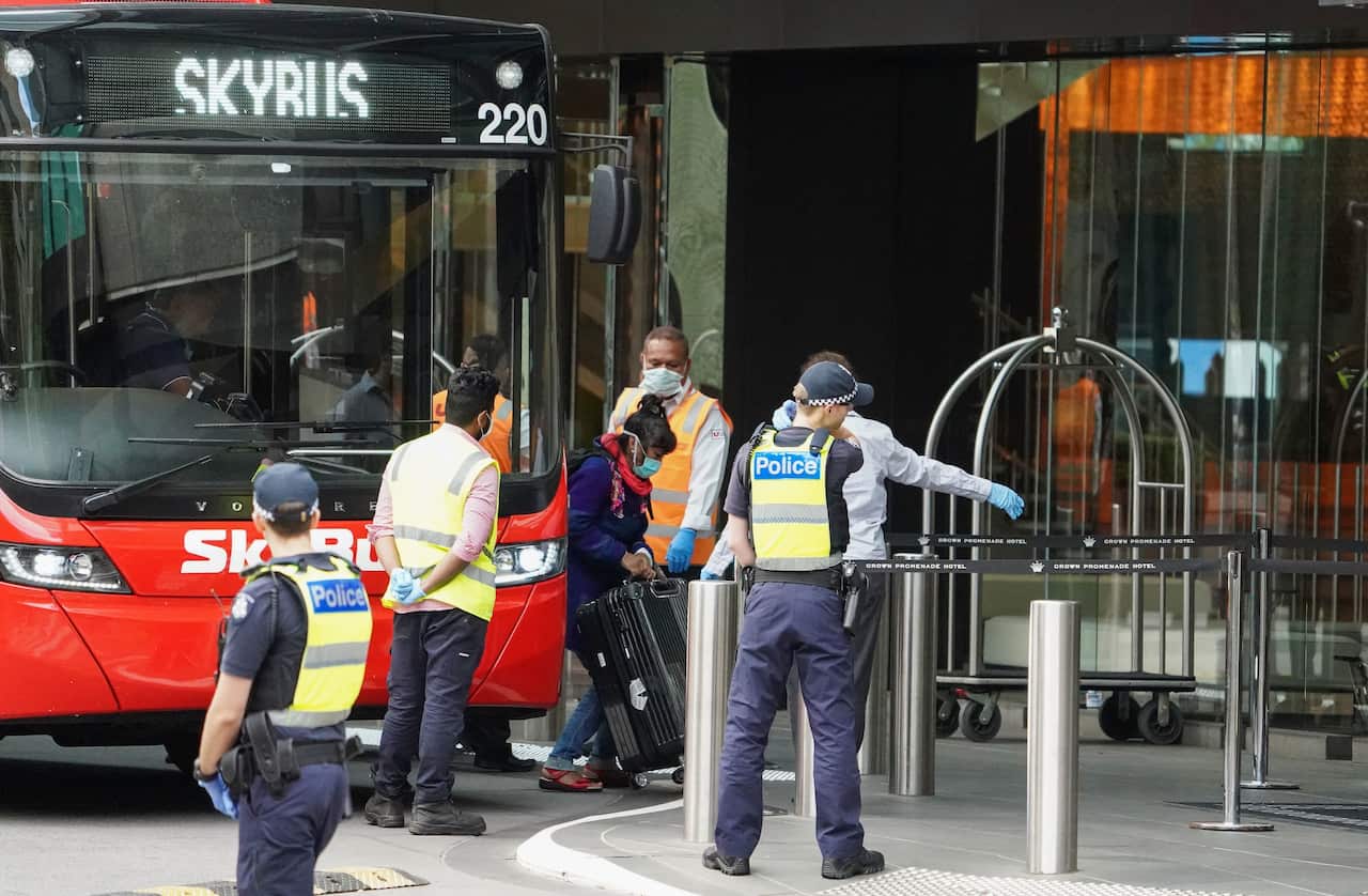 Recently arrived overseas travellers arrive at the Crown Promenade Hotel in Melbourne, Sunday, March 29, 2020.