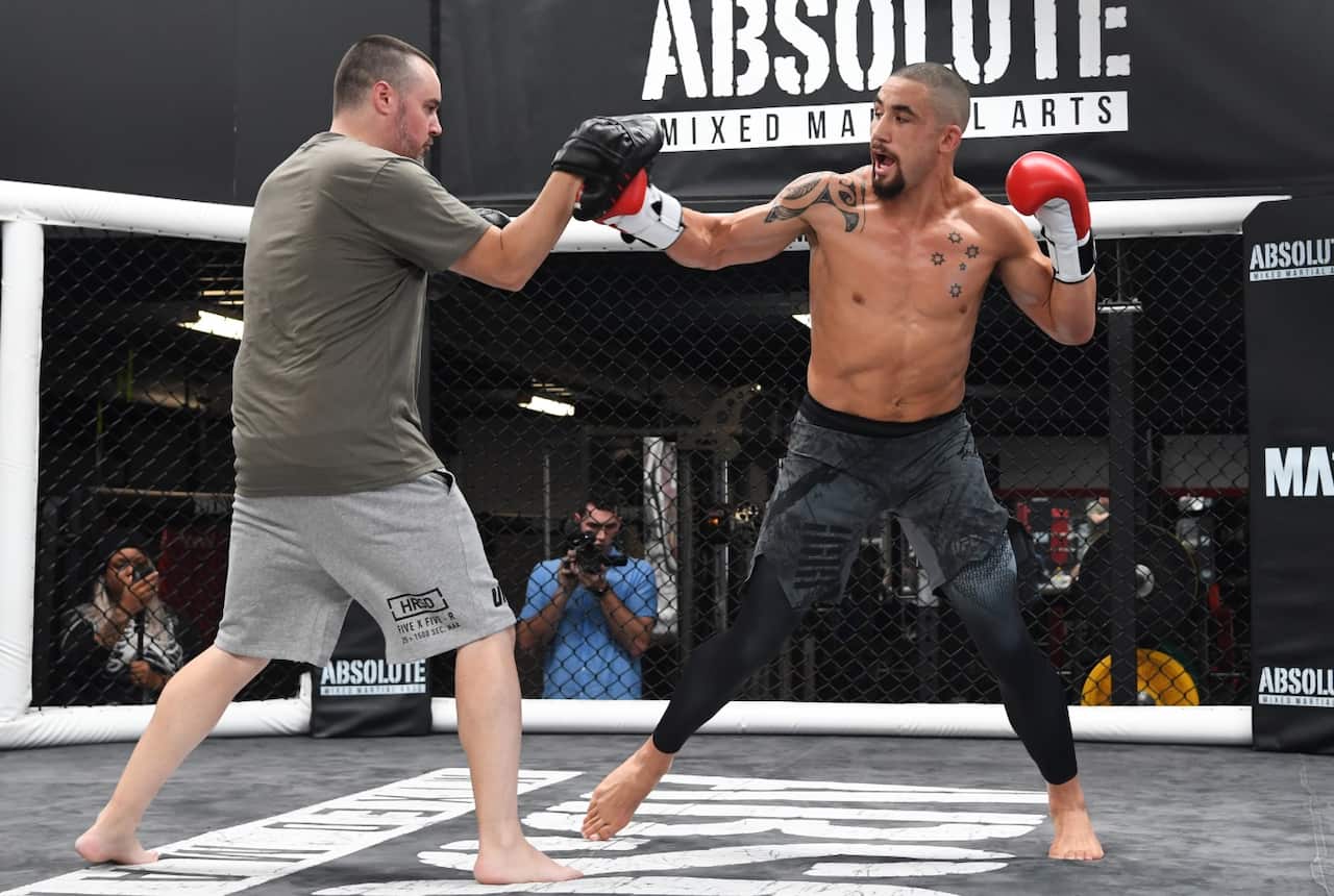 Australian Robert Whittaker (right) in action at a UFC 234 card open training session on February 6. He's set to headline the event in Melbourne.
