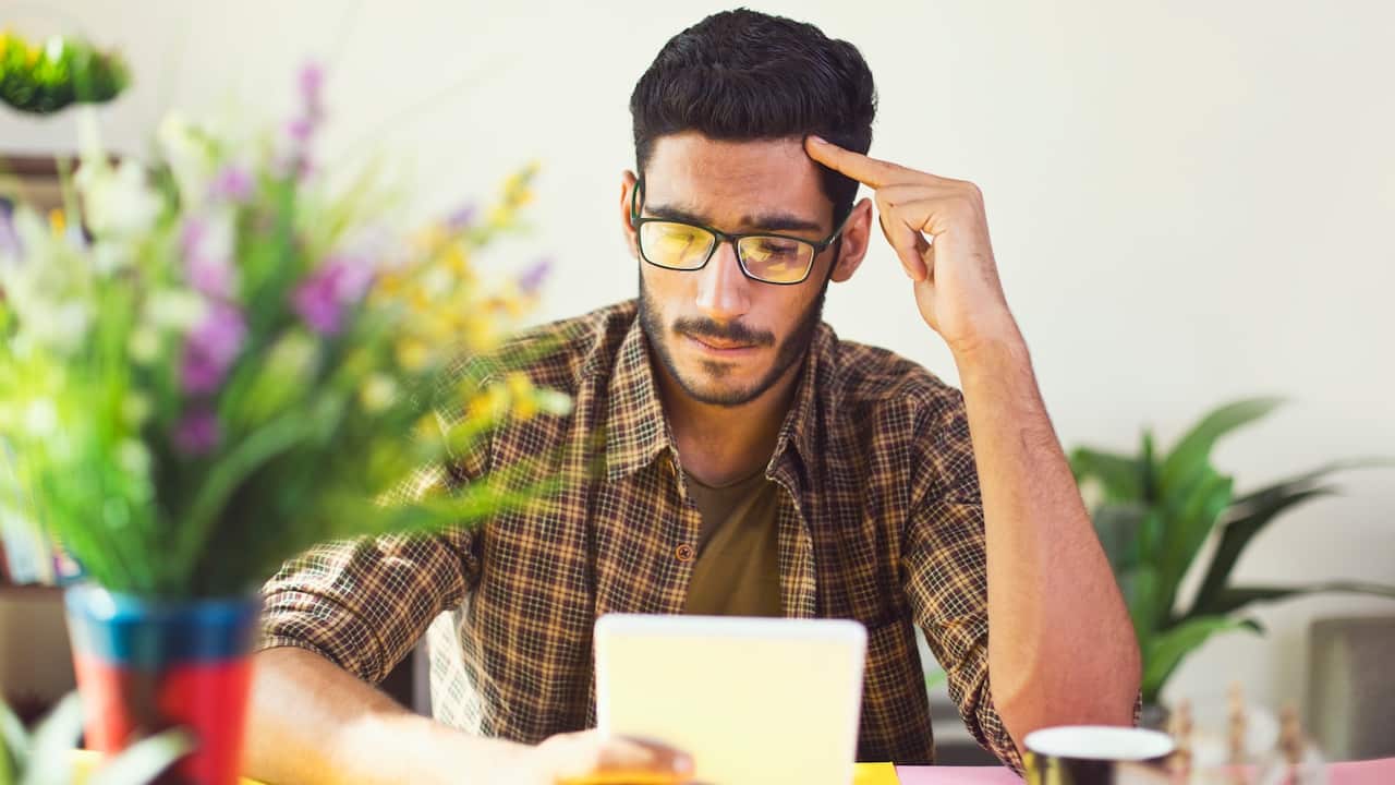 A Young man looking at his tablet