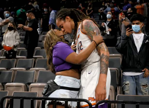 Brittney Griner #42 of the Phoenix Mercury kisses her wife Cherelle Griner in the stands after the Mercury defeated the Las Vegas Aces 87-84 in Game Five of the 2021 WNBA Playoffs semifinals to win the series at Michelob ULTRA Arena on 8 October, 2021 in 