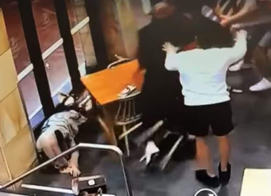 A woman is seen on the ground in this CCTV footage after being beaten up by a stranger