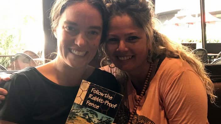 Shari Pilkington giving Sarah Hyde the family copy of the book.