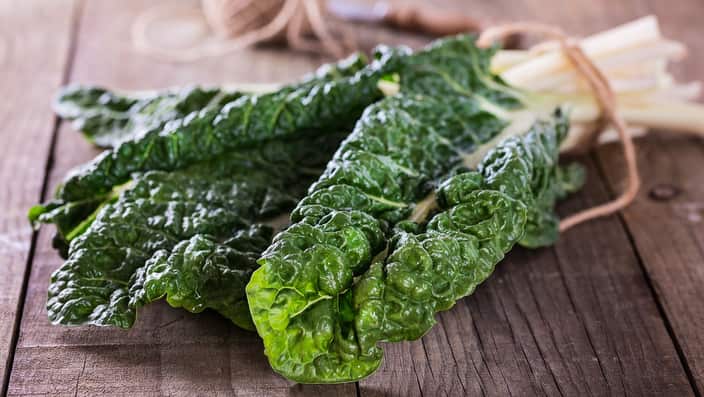 Bunch of silverbeet on a rustic wooden background close up