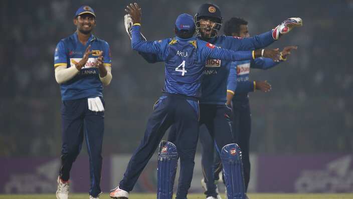 Sri Lanka's Dinesh Chandimal, second right, celebrate with his teammates the dismissal of Bangladesh's Tamim Iqbal during the second and final Twenty20 international cricket match in Sylhet, Bangladesh, Sunday, Feb. 18, 2018. (AP Photo/A.M. Ahad)