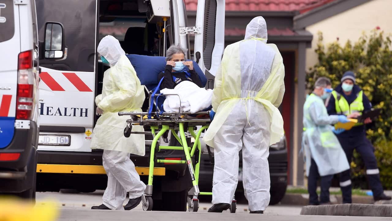 Ambulance officers remove a resident from the St Basil's Home for the Aged in the Melbourne suburb of Fawkner