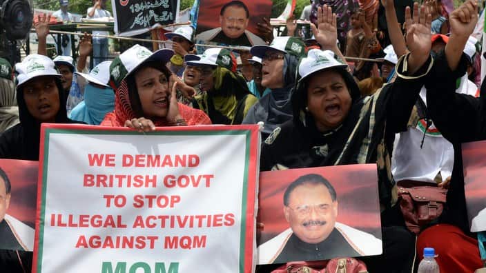 Supporters of Pakistan's MQM party hold photographs of their party leader Altaf Hussain in Karachi on June 6, 2014. ASIF HASSAN/AFP/Getty Images