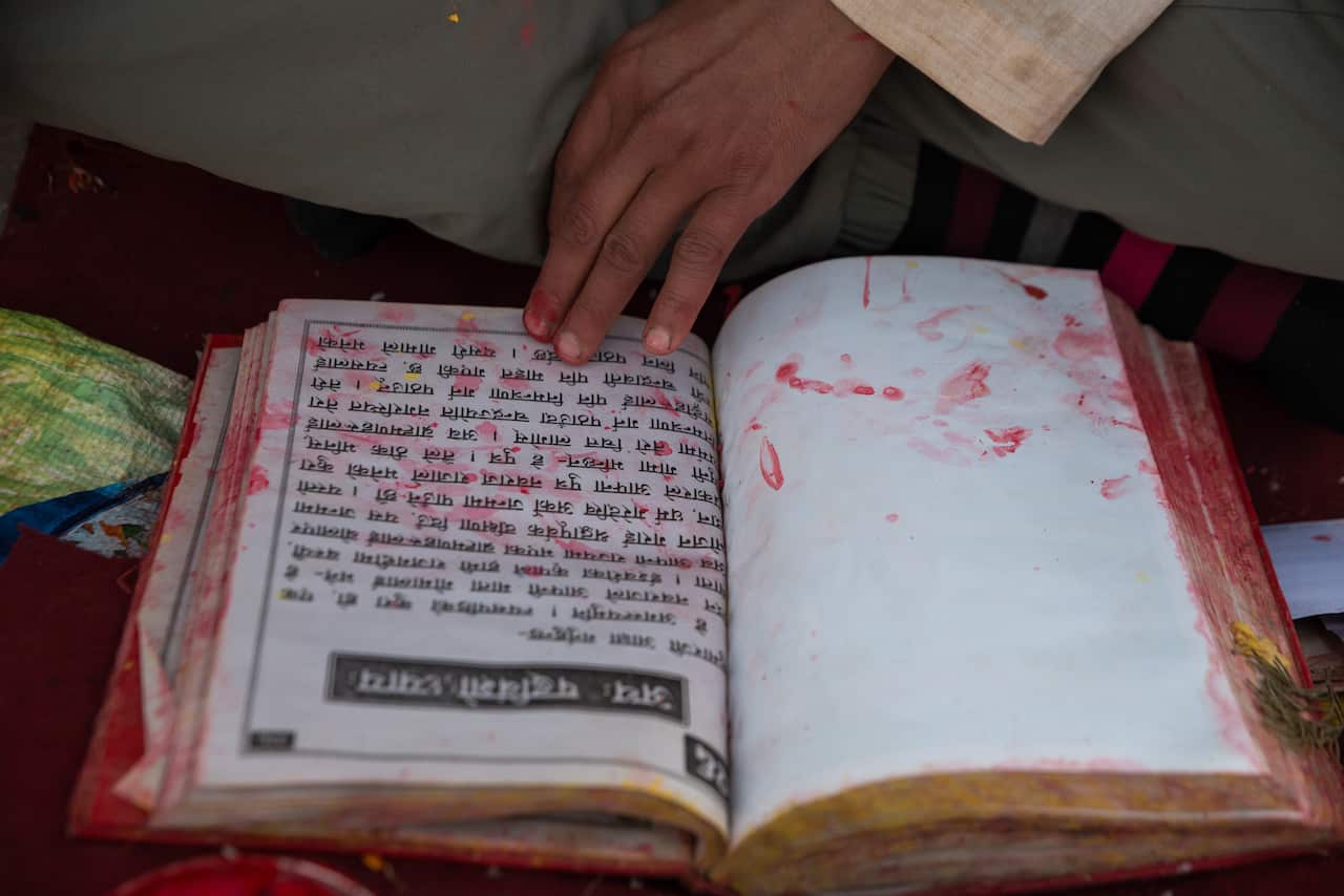 Hindu priest recites the holy book during the festival in Nepal.