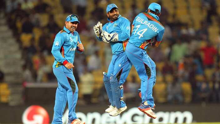 Afghanistan cricketers Shahzad Mohammadi (C) and Gulabdin Naib (R) celebrate after winning their T20 World Cup cricket match /Getty Images)