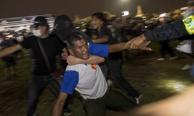 Pro-democracy protesters carry an injured man during the clashes on Sunday. 