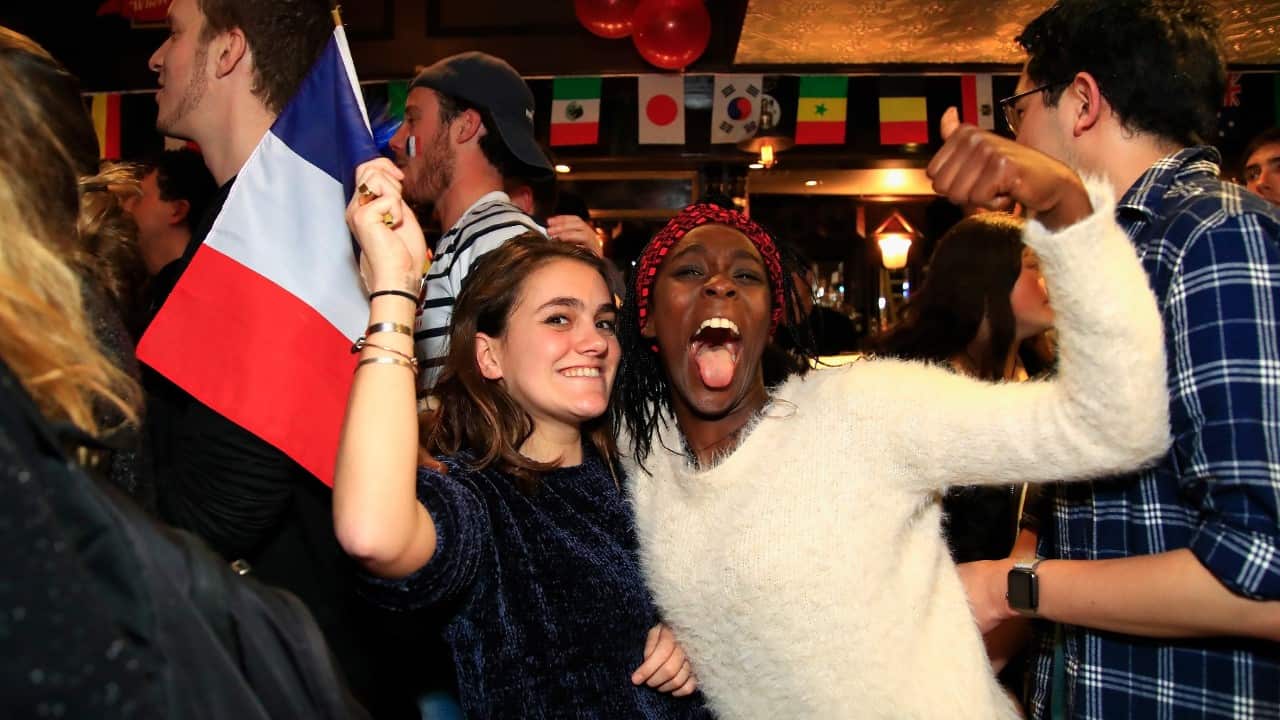 French fans celebrate during celebrations for the FIFA World Cup Final between France and Croatia at Cheers Bar in Sydney, 