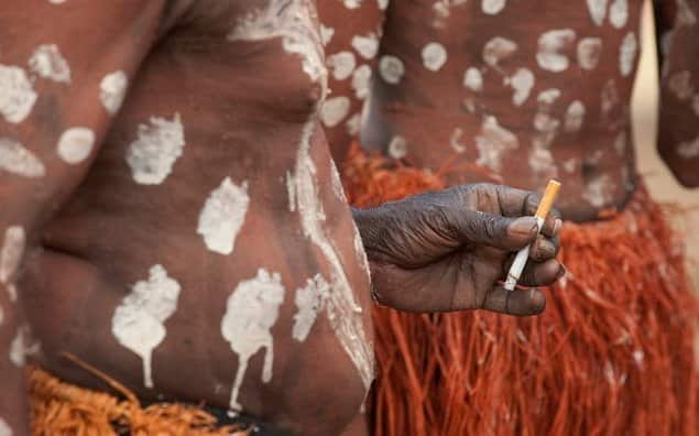 An Aboriginal man smokes a cigarette at a Dance Festival in Laura, north Queensland, Saturday, June 21, 2009. (AAP Image/Dave Hunt) NO ARCHIVING