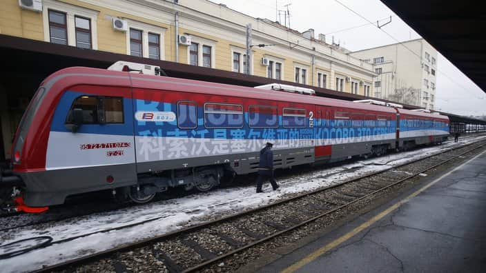 A railroad worker walks by the first train decorated with letters that read "Kosovo is Serbian" written in twenty languages departing from the Belgrade to Mitrovica