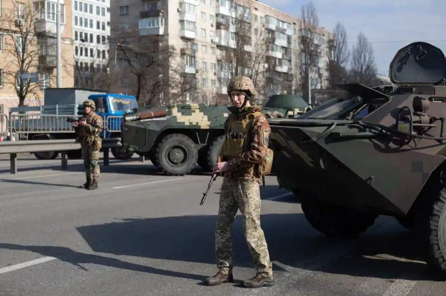 Ukrainian servicemen are on patrol at security checkpoints in Kyiv. 