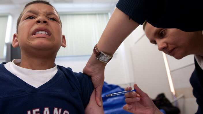 A boy is vaccinated during a day of the
