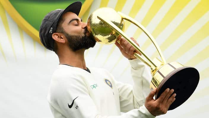 Indian captain Virat Kohli kisses the Border-Gavaskar Trophy