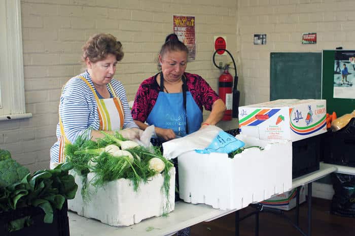 Volunteers prepare food for disadvantaged people in Liverpool, Sydney.