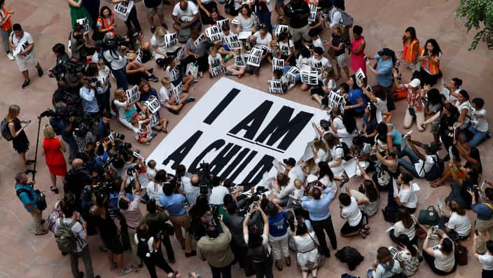 Families with young children protest the separation of immigrant families with a sit-in at the Hart Senate Office Building.