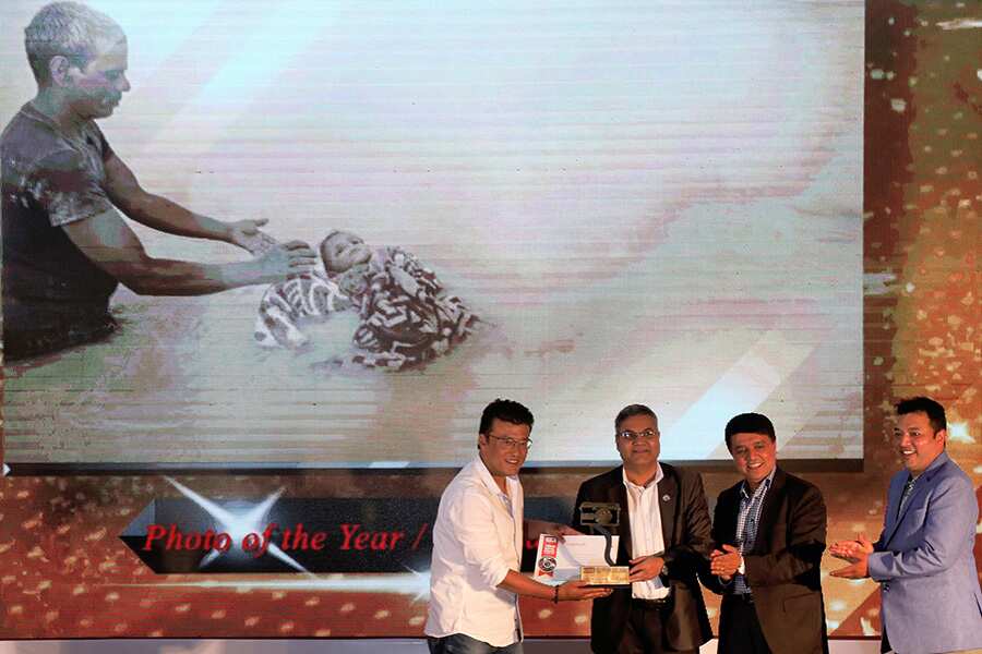 Photo of the year award for 2018 given to Narendra Shrestha for his photo about a father cremating his dead child's body in Koshi River.