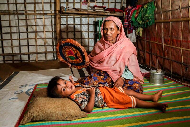 Yanus mother taking care of a child in the camp.