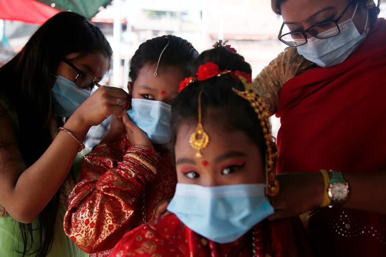 Young Newari girls prepare for an Ihi ceremony in Kathmandu, Nepal, Friday, Dec. 4, 2020. 