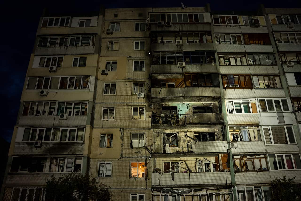 A residential building with significant damage to several balconies.