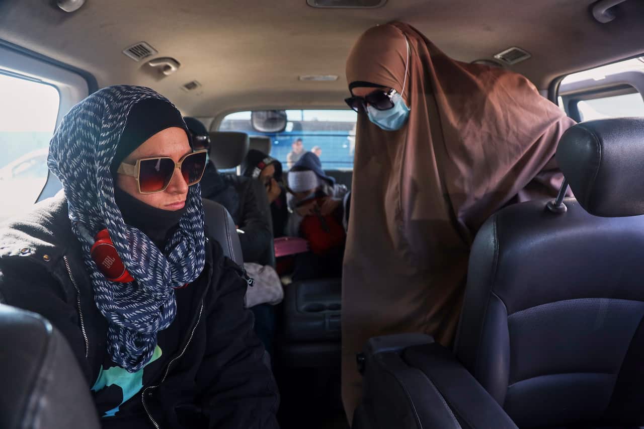 A group of Muslim women boarding a van