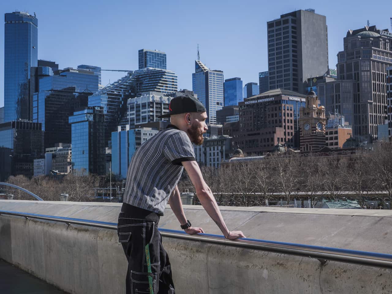 A person looks out towards a city skyline.