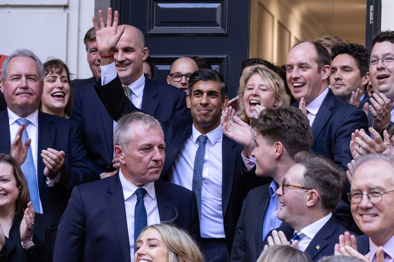 Rishi Sunak surrounded by Conservative Party colleagues.