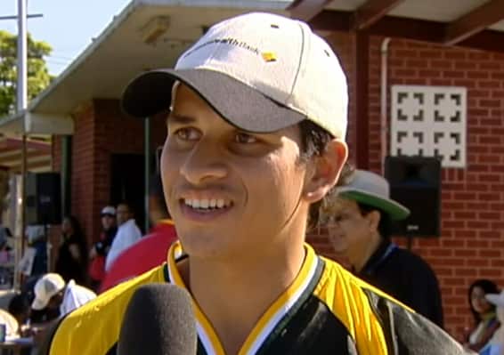 Australian cricketer Usman Khawaja as a teenager in a yellow jersey and a white cap.