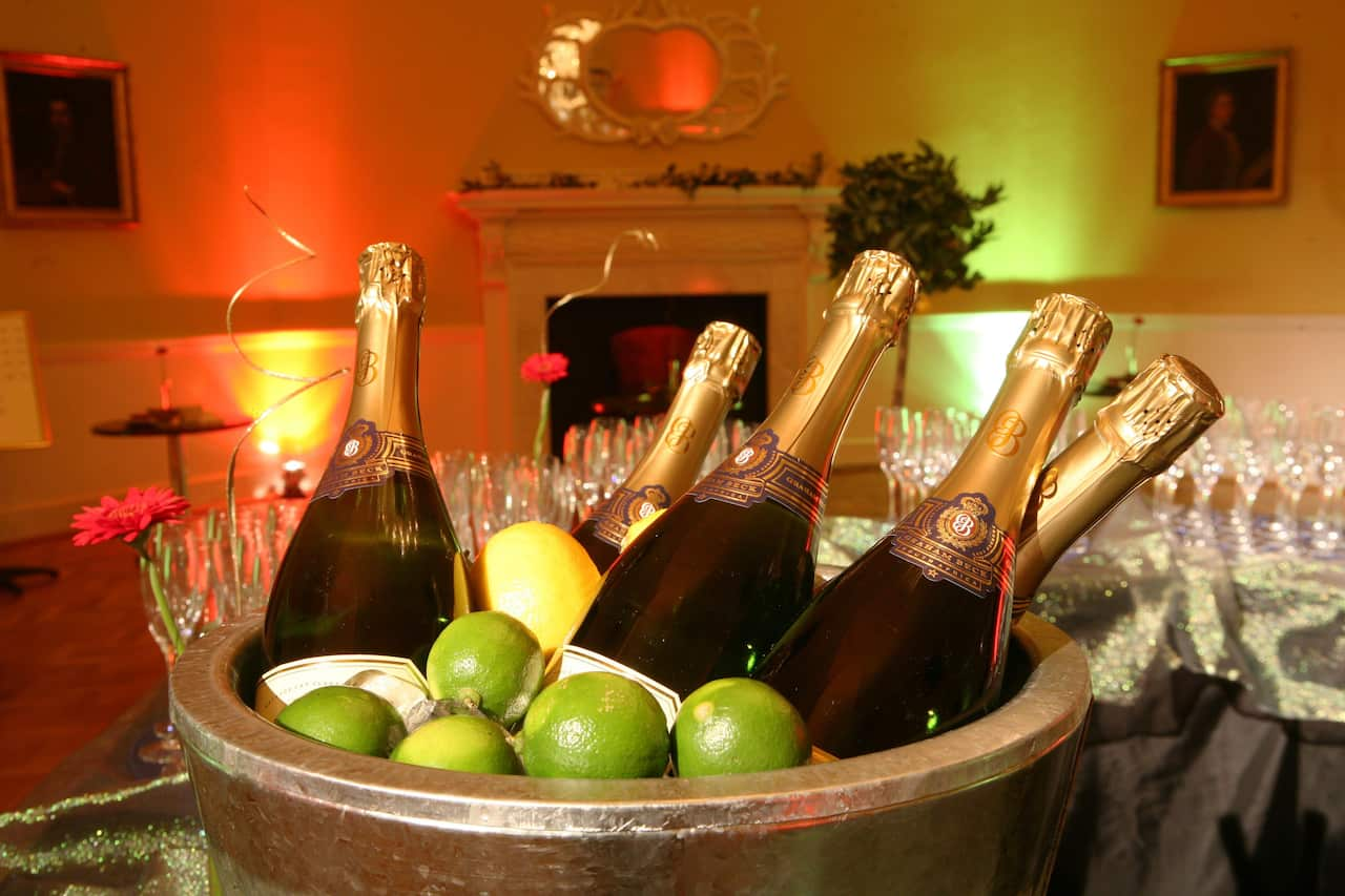 A bucket of champagne and green apples